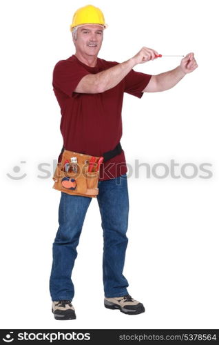 Construction worker using a screwdriver in empty copyspace