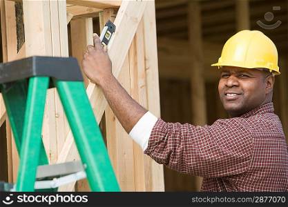 Construction worker using spirit level on building