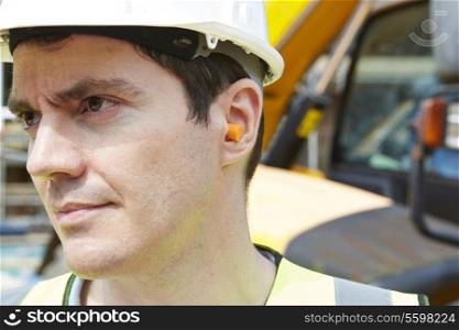 Construction Worker Wearing Protective Ear Plugs