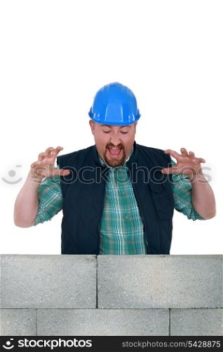 Construction worker with a block wall