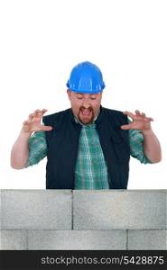 Construction worker with a block wall