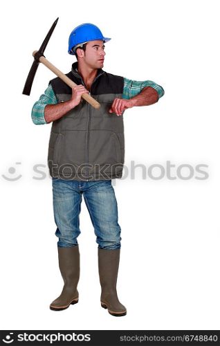 Construction worker with a pickaxe leaning on empty copyspace
