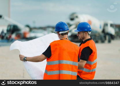 Construction worker with building plans on construction site