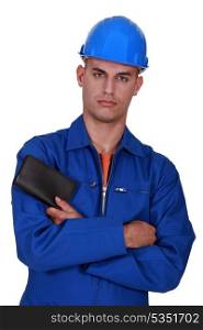 construction worker with folded arms holding wallet