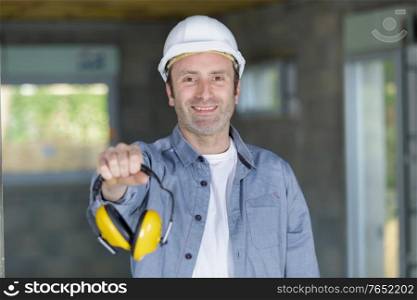 construction worker with noise cancelling earphones