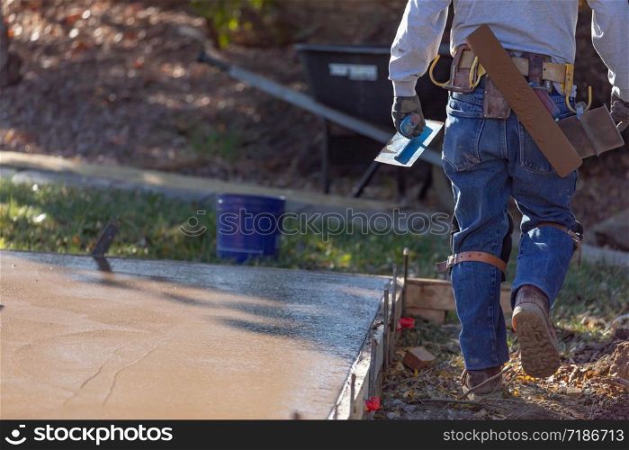 Construction Worker With Trowel Tools Near Wet Deck Cement