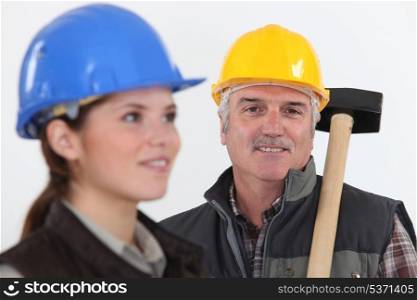 Construction worker with young female helper