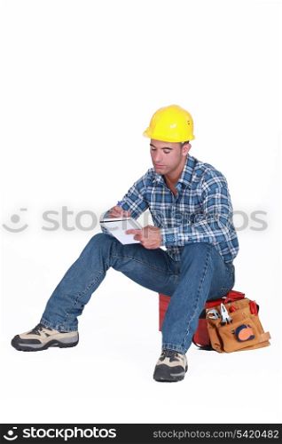 Construction worker writing in a notebook