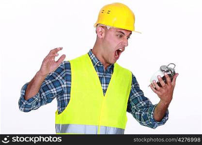 Construction worker yelling at an alarm clock