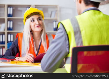 Construction workers having discussion in office before starting. Construction workers having discussion in office before starting project. Construction workers having discussion in office before starting