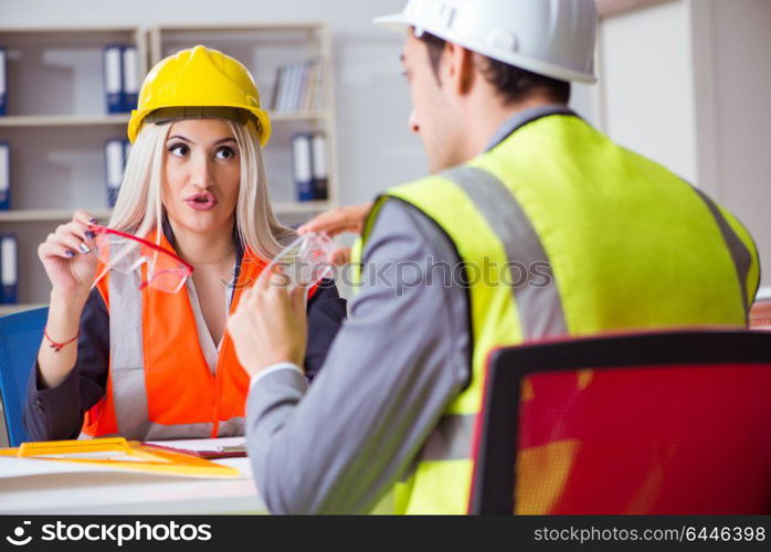 Construction workers having discussion in office before starting project. Construction workers having discussion in office before starting