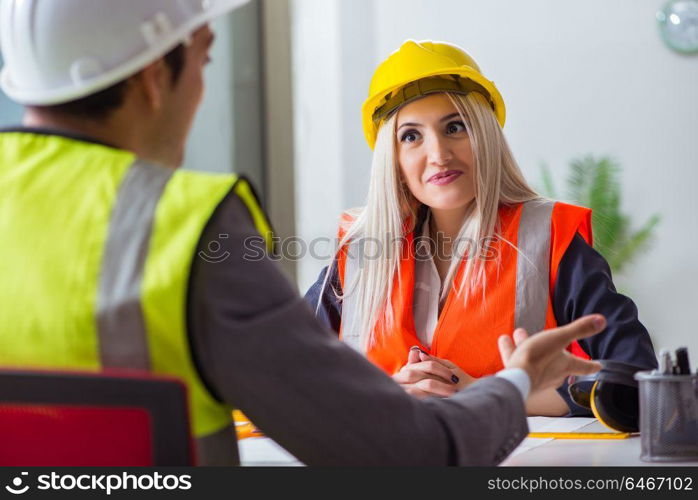 Construction workers having discussion in office before starting project. Construction workers having discussion in office before starting