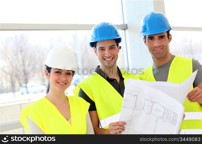 Construction workers looking at building plan