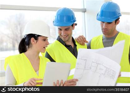 Construction workers looking at building plan