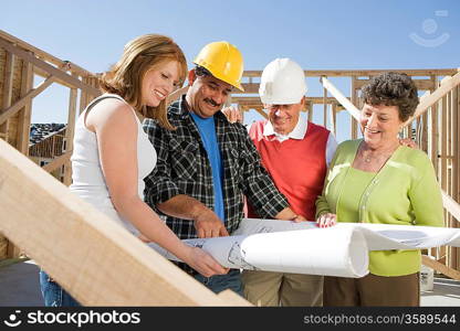 Construction workers observing plans on construction site