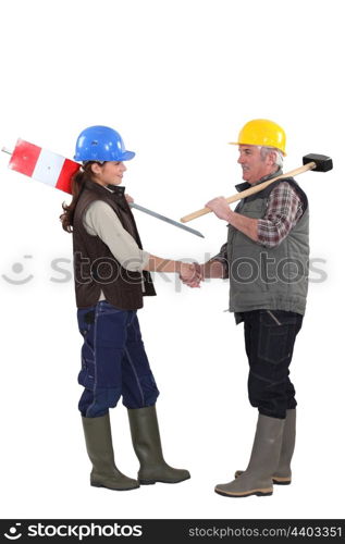 Construction workers shaking hands