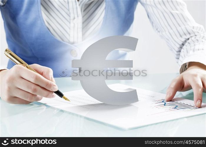 Consultation and advice help. Close view of businesswoman writing with pen and currency euro sign