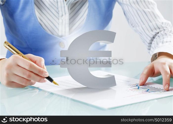 Consultation and advice help. Close view of businesswoman writing with pen and currency euro sign