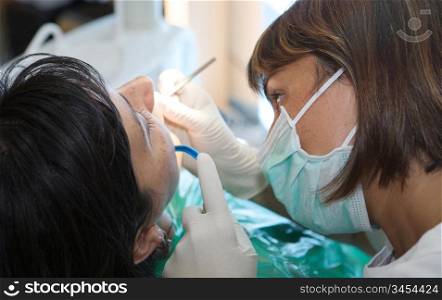 consulting a dentist during a dental cleaning