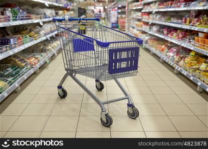 consumerism concept - empty shopping cart or trolley at supermarket. empty shopping cart or trolley at supermarket