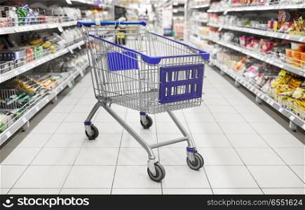 consumerism concept - empty shopping cart or trolley at supermarket. empty shopping cart or trolley at supermarket. empty shopping cart or trolley at supermarket
