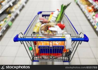 consumerism concept - food in shopping cart or trolley at supermarket. food in shopping cart or trolley at supermarket. food in shopping cart or trolley at supermarket