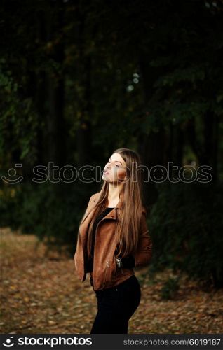 Consumerism, fashion and people concept - beautiful hippie young slim woman wearing boho chic clothes, suede jacket and trendy jeans. Autumn portrait.