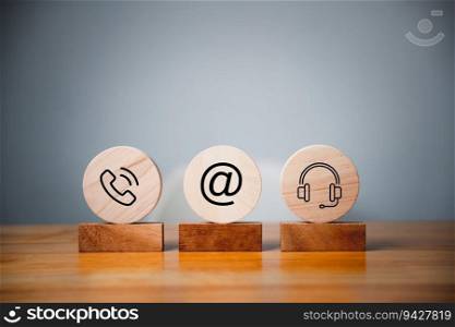Contact us concept on website page. Customer support hotline and people connection. Wood label circle with email, phone, address, chat message, and headset icons. Business communication banner.