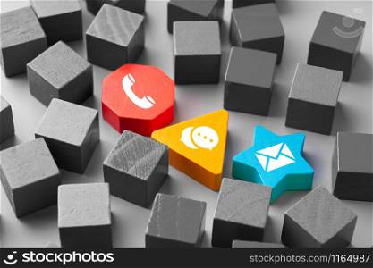 Contact us icon on colorful puzzle with hand