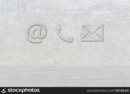 Contact Us. Phone, email and post icons on cement wall