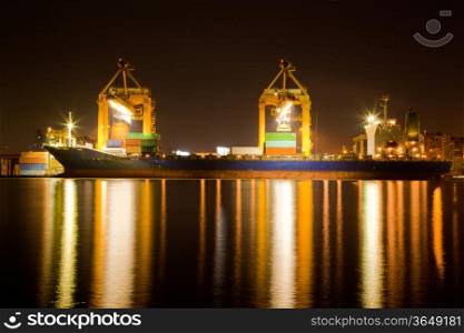 Container Cargo freight Industrial ship with working crane bridge unloading and loading goods in Bangkok shipyard Terminal at night for Logistic Import Export background