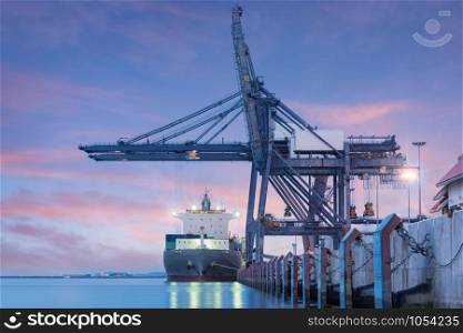 Container Cargo freight ship by crane bridge, logistics harbor at sunrise