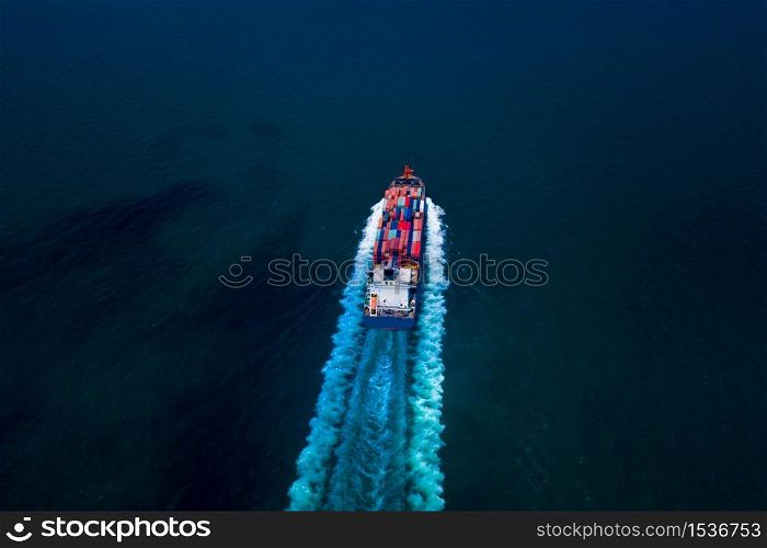 container cargo ship, business freight shipping international by container cargo ship in the sailing open sea at night process aerial view from drone