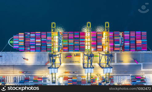 Container cargo ship in import export business logistic at night, Freight transportation container ship, Aerial view.