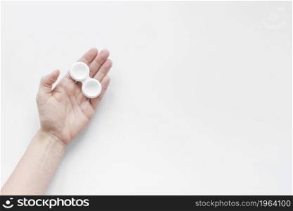 container lenses hand white background. High resolution photo. container lenses hand white background. High quality photo