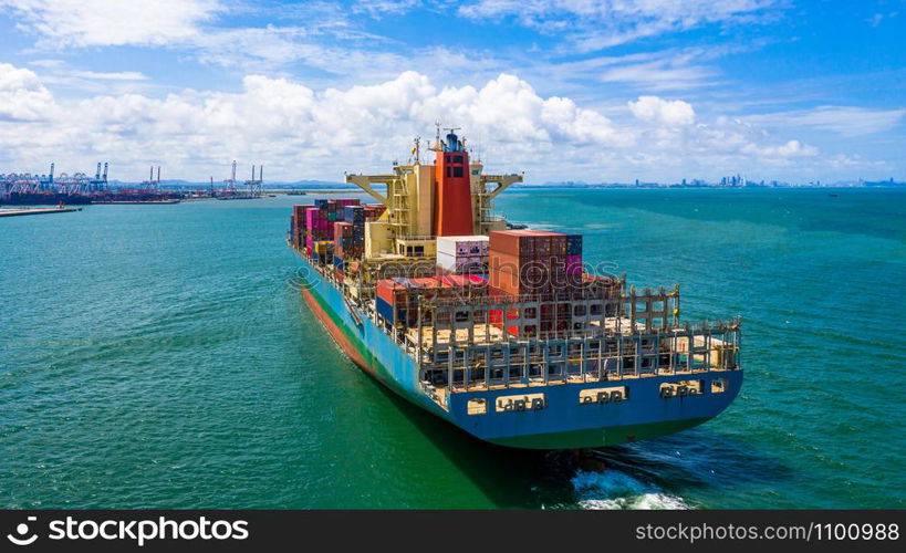 Container ship at industrial port in import export business logistic and transportation of international by container ship in the open sea.