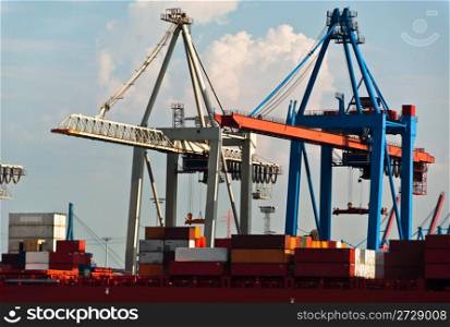 Container ship being unloaded using massive cranes in Hamburg Dock, Germany. Hamburg is the second biggest container port in Europe and can serve the largest ships.