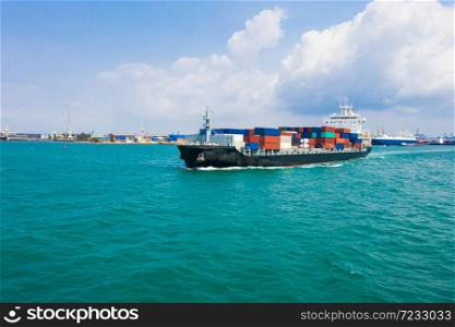 Container ship in export and import business and logistics. Shipping cargo to harbor transport International and shipping port background Thailand