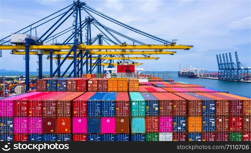 Container ship loading and unloading in deep sea port, Aerial top view of business logistic import and export freight transportation by container ship in open sea.