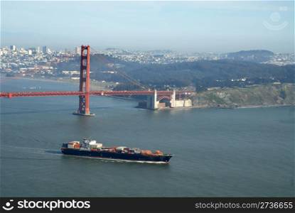 Container ship passing under the Golden Gate Bridge, San Francisco, California