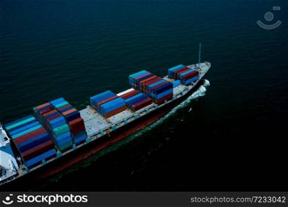 Container ship sailing the ocean, Business cargo logistics service and transportation of International container ship in the ocean freight transportation, Aerial view at night process