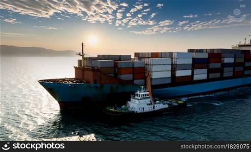 container ship transporting large cargo logistic import export goods internationally worldwide including Asia Pacific and Europe, industry business service transportation by container ship in Ocean and over sunlight background photograph aerial view from drone,