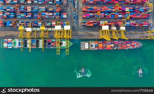 Container ship working at industrial port, Business import and export logistic and transportation of International by container ship in the open sea, Aerial view container ship loading and unloading.