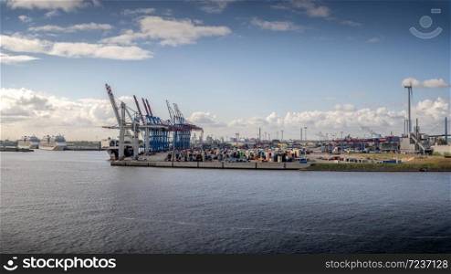 Container terminal in sunny weather with 2 cruise ships in Hamburg