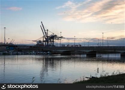 Container Terminal, Shipyard and Cranes at Sunset and Their Reflection. Container Terminal, Shipyard and Cranes at Sunset and Their Refl
