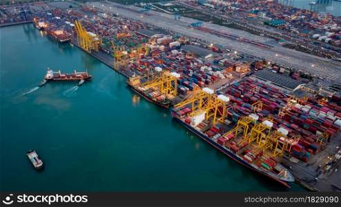 Containers ship and tugboat dragging to shipping ports cargo logistic freight load unloading by crane forwarding industry import export international worldwide, business services transportation of goods in ocean waters Asia Pacific and Europe photograph aerial view from drone