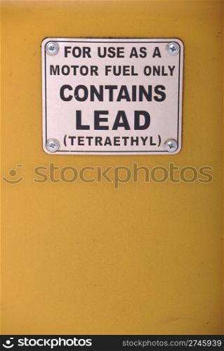 contains lead vintage sign on a yellow gas pump background