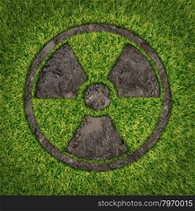 Contaminated soil concept with a green grass and the radio active symbol embosed in the ground exposing the poisoned earth as an icon of environmental disaster after a nuclear disaster and the dangerous fallout that lingers on.
