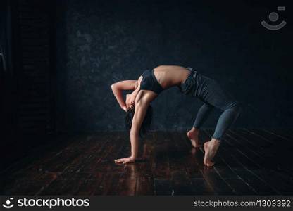 Contemp dancing female performer exercise in dance class. Woman pose in studio, acrobat body flexibility