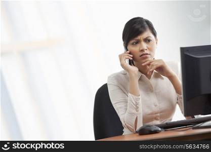 Contemplative businesswoman on call
